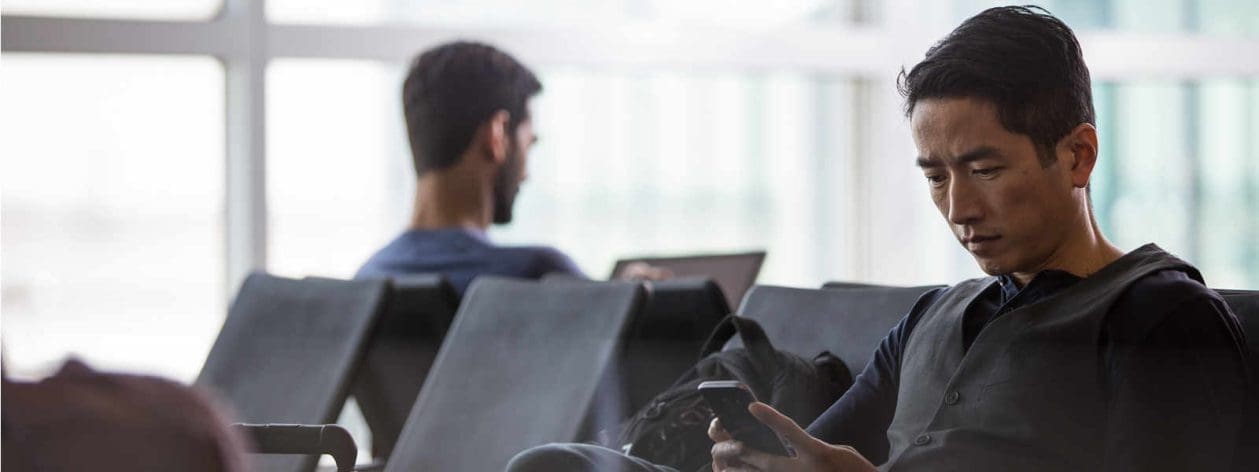 phone user in airport lounge