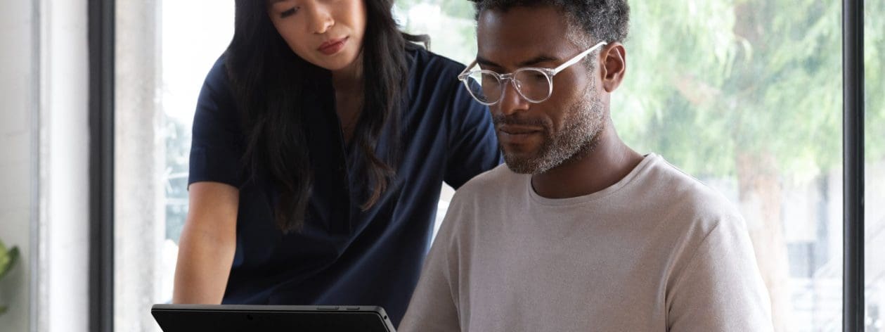 male and female working on surface device