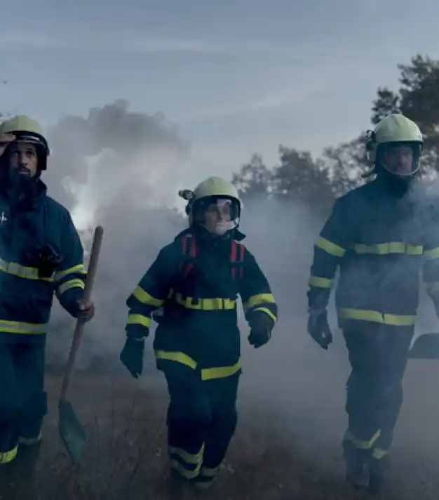 firefighters walking toward a fire